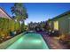 A luxurious backyard pool, hot tub, palm trees, and plenty of lounge space at 748 Puerto Real Ct, Las Vegas, NV 89138