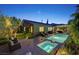 Beautiful backyard pool and spa area with covered patio and elegant landscaping at night at 748 Puerto Real Ct, Las Vegas, NV 89138