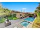 Beautiful backyard pool and spa area with covered patio and elegant landscaping, perfect for outdoor entertaining at 748 Puerto Real Ct, Las Vegas, NV 89138