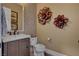 Chic powder room showcasing textured walls, modern fixtures, and a decorative mirror at 748 Puerto Real Ct, Las Vegas, NV 89138