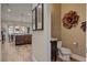Stylish powder room featuring wood floors, designer wallpaper and accents, and custom sink at 748 Puerto Real Ct, Las Vegas, NV 89138