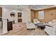 Cozy sitting room with tan accent wall, plush white seating, stylish decor, and beautiful natural light at 748 Puerto Real Ct, Las Vegas, NV 89138