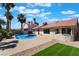 Inviting backyard featuring a sparkling swimming pool, lush greenery and a covered patio for outdoor entertaining at 8000 Vista Twilight Dr, Las Vegas, NV 89123