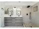 Stylish bathroom featuring dual sinks, modern lighting, tiled floors, and a shower at 8000 Vista Twilight Dr, Las Vegas, NV 89123