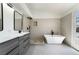 Modern bathroom featuring dual sinks, a soaking tub, a tiled shower, and wood floors at 8000 Vista Twilight Dr, Las Vegas, NV 89123