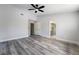 A bright bedroom features wood floors, neutral walls, and access to an en suite bathroom at 8000 Vista Twilight Dr, Las Vegas, NV 89123