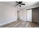 Bedroom featuring hardwood floors, a ceiling fan, and a closet with sliding doors at 8000 Vista Twilight Dr, Las Vegas, NV 89123
