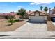 Charming single-story home featuring a well-maintained yard, mature trees, and a spacious two-car garage at 8000 Vista Twilight Dr, Las Vegas, NV 89123