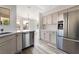 Modern kitchen featuring stainless steel appliances, light colored cabinets and an island with countertop seating at 8000 Vista Twilight Dr, Las Vegas, NV 89123