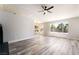 Bright living room offering an open floor plan, a ceiling fan, and large windows at 8000 Vista Twilight Dr, Las Vegas, NV 89123