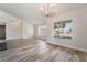 Bright living room featuring wood-look floors, large windows, modern lighting and an open floorplan design at 8000 Vista Twilight Dr, Las Vegas, NV 89123