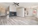Spacious living room with a decorative fireplace, wood flooring, and ample natural light at 8000 Vista Twilight Dr, Las Vegas, NV 89123
