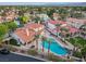 Picture perfect aerial view of a home with a sparkling pool, landscaped yard, and elegant red tile roof at 8104 Wispy Sage Way, Las Vegas, NV 89149