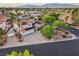 Aerial view of a home with solar panels, a circular driveway, and mature trees at 8104 Wispy Sage Way, Las Vegas, NV 89149