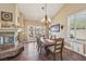 Open dining area with cozy fireplace, leading to outdoor patio through glass doors at 8104 Wispy Sage Way, Las Vegas, NV 89149