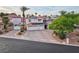 Exterior aerial view of a home with a three car garage, solar panels, and an expansive driveway at 8104 Wispy Sage Way, Las Vegas, NV 89149
