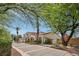 Two story home with a long driveway, three-car garage, desert landscaping, and tile roof at 8104 Wispy Sage Way, Las Vegas, NV 89149