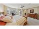 Sunlit main bedroom featuring a large bed and access to outdoor patio at 8104 Wispy Sage Way, Las Vegas, NV 89149