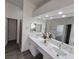 Bathroom featuring double sinks, a large mirror, and modern fixtures at 8545 Summer Vista Ave, Las Vegas, NV 89145