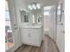Bathroom vanity with single sink, mirror, and access to the backyard at 8545 Summer Vista Ave, Las Vegas, NV 89145