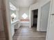 Bright bathroom featuring double sinks, marble countertop, and tub with tile accents at 8545 Summer Vista Ave, Las Vegas, NV 89145