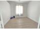 Bright bedroom with wood-look flooring and window with light-filtering curtains at 8545 Summer Vista Ave, Las Vegas, NV 89145