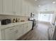 Well-lit kitchen featuring white cabinets, stainless steel appliances, and elegant countertops at 8545 Summer Vista Ave, Las Vegas, NV 89145