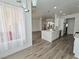 Modern open concept kitchen, stainless steel appliances, quartz counters, and wood floors at 8545 Summer Vista Ave, Las Vegas, NV 89145