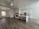 Bright, open living space with fireplace, kitchen view, and wood-style flooring at 8545 Summer Vista Ave, Las Vegas, NV 89145