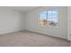 Well-lit bedroom with neutral carpeting and a large window offering neighborhood views at 9543 Havasu Canyon Ave, Las Vegas, NV 89166