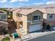 Two-story home with a neutral color scheme, tile roof, and attached garage in a suburban neighborhood at 9543 Havasu Canyon Ave, Las Vegas, NV 89166