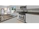 Bright kitchen with granite countertops, stainless steel range, and a view of the backyard at 9543 Havasu Canyon Ave, Las Vegas, NV 89166