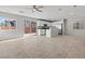 Open-concept living space with tiled floors, a ceiling fan, and sliding glass doors to the backyard at 9543 Havasu Canyon Ave, Las Vegas, NV 89166