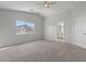 Main bedroom with vaulted ceiling, neutral carpet and attached bathroom at 9543 Havasu Canyon Ave, Las Vegas, NV 89166