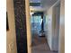 Hallway leading to a bright living space with sliding glass doors and a balcony at , Las Vegas, NV 89183