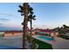 A high angle of the expansive outdoor pool and entertainment space, with palm trees in the distance at 10280 W La Mancha Ave, Las Vegas, NV 89149