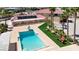 Aerial view showcasing a swimming pool, artificial turf, palm trees and ample space for outdoor activities at 10280 W La Mancha Ave, Las Vegas, NV 89149