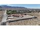 Expansive home with red tile roof, lush landscaping, sparkling pool and mountain views in the distance at 10280 W La Mancha Ave, Las Vegas, NV 89149