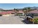 Expansive home with red tile roof, lush landscaping, sparkling pool and elevated deck overlooking backyard at 10280 W La Mancha Ave, Las Vegas, NV 89149