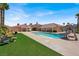 Expansive backyard with in-ground pool, slide, and an artificial turf area for outdoor enjoyment at 10280 W La Mancha Ave, Las Vegas, NV 89149