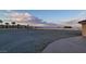 Expansive gravel backyard with palm trees and mountain views offers a serene outdoor setting at 10280 W La Mancha Ave, Las Vegas, NV 89149