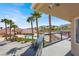 Balcony view of the pool, palm trees, and mountains in the distance at 10280 W La Mancha Ave, Las Vegas, NV 89149