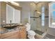 Modern bathroom featuring a glass shower, custom vanity, and stylish fixtures at 10280 W La Mancha Ave, Las Vegas, NV 89149