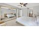 Spacious bedroom featuring a large mirror, neutral paint, and wood look tile flooring at 10280 W La Mancha Ave, Las Vegas, NV 89149