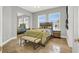 Bright bedroom featuring a decorative ceiling fan, tiled flooring, and a mirrored closet at 10280 W La Mancha Ave, Las Vegas, NV 89149