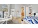 Bright bedroom featuring bookshelves, study table, and view to the bathroom at 10280 W La Mancha Ave, Las Vegas, NV 89149