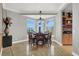 Dining room with a table seating eight, a bay window, and built-in cabinets at 10280 W La Mancha Ave, Las Vegas, NV 89149