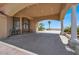 Covered entrance highlighting the grand double doors, archway, and ample parking space with desert views at 10280 W La Mancha Ave, Las Vegas, NV 89149