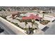 Aerial view of a sprawling estate featuring a red tile roof, palm trees, and a sparkling blue pool at 10280 W La Mancha Ave, Las Vegas, NV 89149