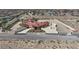 Aerial view of a large estate with red tile roof and palm trees, surrounded by a white perimeter fence at 10280 W La Mancha Ave, Las Vegas, NV 89149